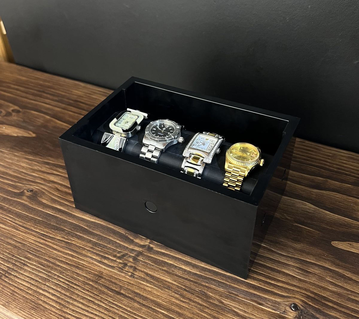 Black Cowan Cases watch, bracelet and necklace case with slide-out bar holding watches
