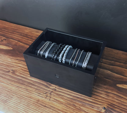 Black Cowan Cases watch, bracelet and necklace case filled with bracelets, side view showing the magnetic button