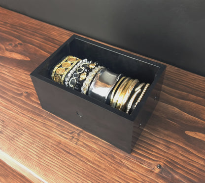 Black Cowan Cases watch, bracelet and necklace case filled with bracelets, angled view