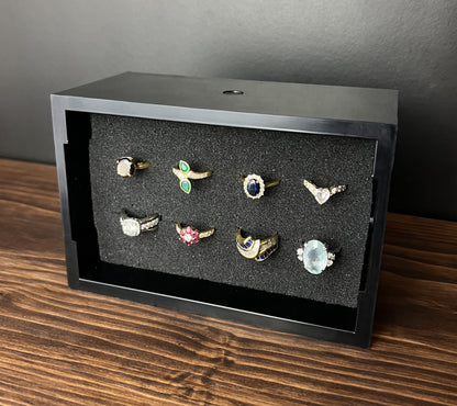 Black Cowan Cases earring, pendant, ring and cufflink case with pre-scored foam bed, filled with rings, standing upright